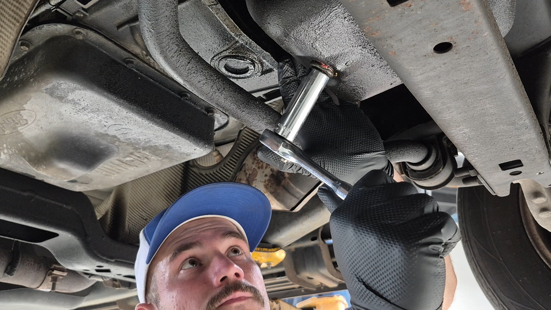 SP Automotive technician working underneath a vehicle